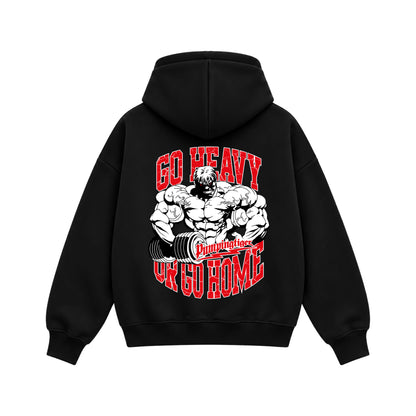 Back view of Go Heavy Or Go Home black boxy zipper hoodie featuring muscular bodybuilder artwork and bold red and white typography